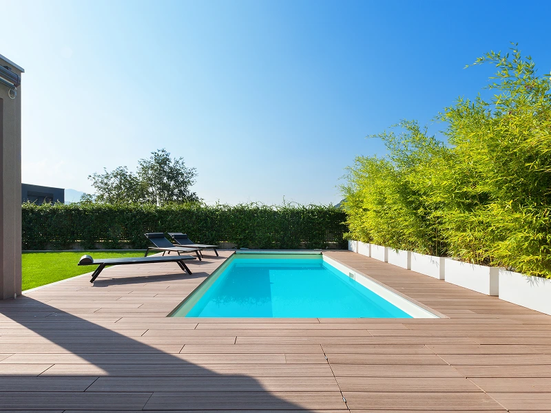Here's an alt tag for the image: Modern backyard pool with lounge chairs.